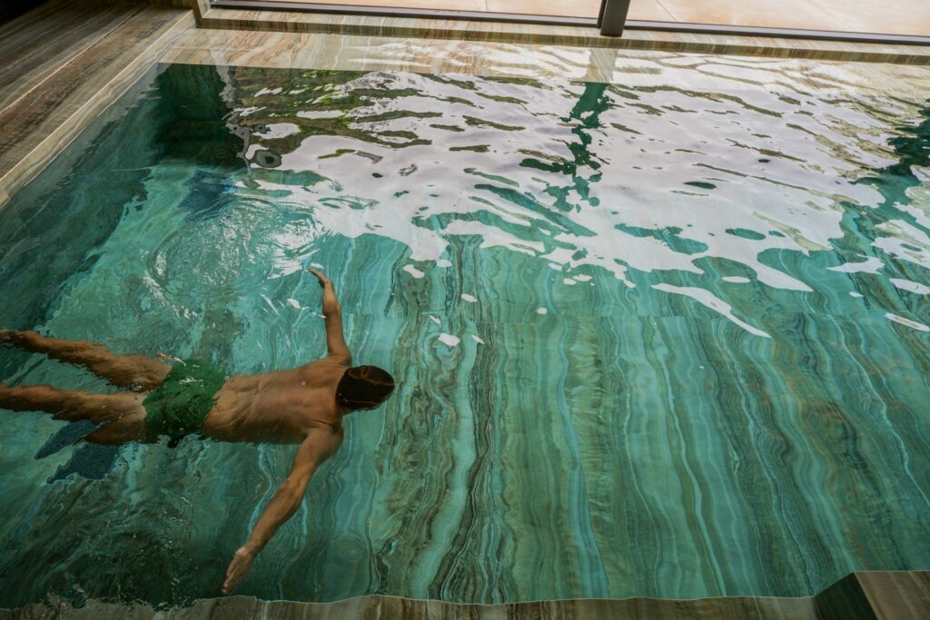 A man swimming in an indoor swimming pool in an Edmonton Condo
